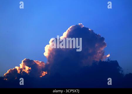 Sunset Cloud Formation with Illuminated Edges Stock Photo