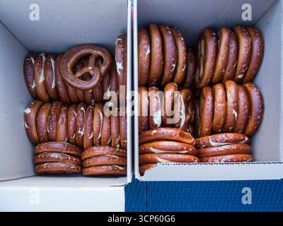 Top view of two cardboard boxes containing pretzels for sale. Stock Photo