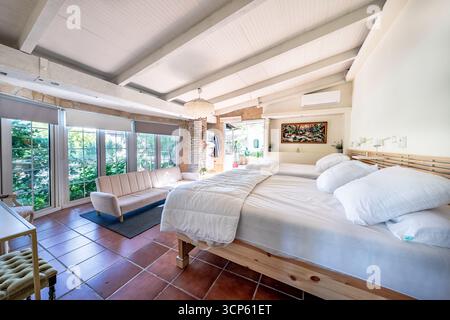Spacious and Bright Bedroom Living Area with Garden View in luxury mediterranean real estate Stock Photo