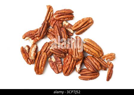 Pecan nuts isolated on white. Brown organic kernels closeup. Natural healthy snack food. Protein rich vegan ingredient. Rustic agriculture harvest. Stock Photo