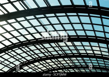 Modern glass roof architecture with steel grid construction. Transparent structure with geometric pattern. Abstract background of urban architecture. Stock Photo