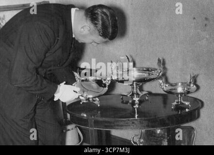 Centenary Cup - Final inspection of the Centenary Cup before it went into a Collins Street jeweller's shop window. The trophy chosen by the Victoria racing club for the centenary cup to be decided at Flemington on March 2. February 26, 1940. Stock Photo