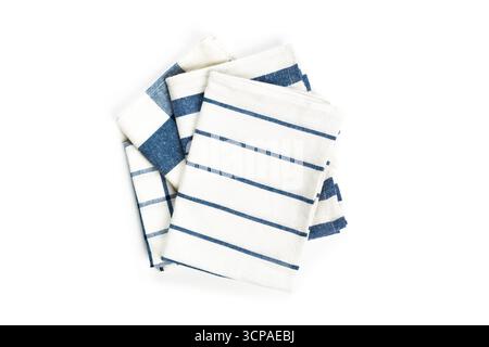 Striped kitchen towels neatly stacked in a casual arrangement on a white background Stock Photo