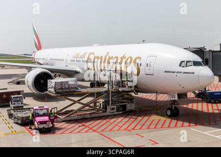 Warsaw, Poland, 14.07.2021. Boeing 777-300 ER Emirates Airlines at Warsaw Chopin Airport WAW apron being loaded with cargo before departure to Dubai. Stock Photo