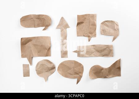 Various crumpled paper speech bubbles arranged artistically on a white background Stock Photo