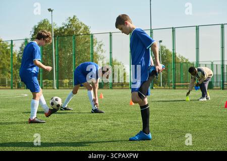 Group of Teenager Boys Warming up and Practicing Soccer Drills Outdoors Stock Photo