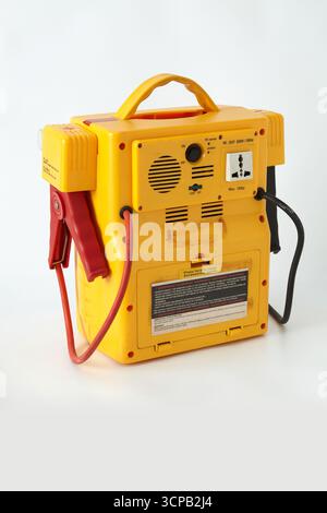 Back view of an old portable power station with integrated air compressor and inverter, also with emergency lights, jumper cables and pressure gauge Stock Photo