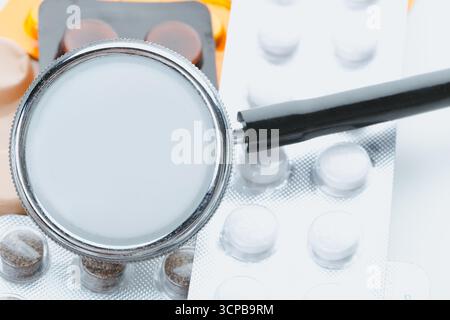 Medical tools and medications arranged on a workspace in a bright setting Stock Photo