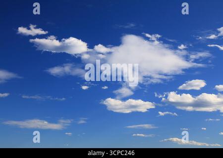 White clouds blue sky background. White fluffly clouds texture. Stock Photo