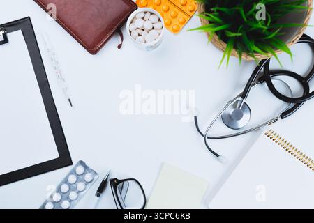 Medical tools and supplies arranged on a white surface during a healthcare work session Stock Photo