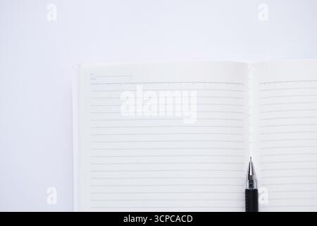Close-up of blank notebook and pen isolated on white background Stock Photo
