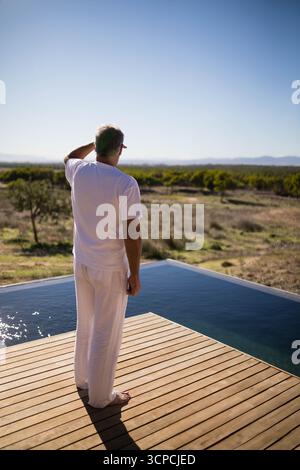 Timber Processing Decks A barefoot person standing on dry sandy ground beside partially visible ...