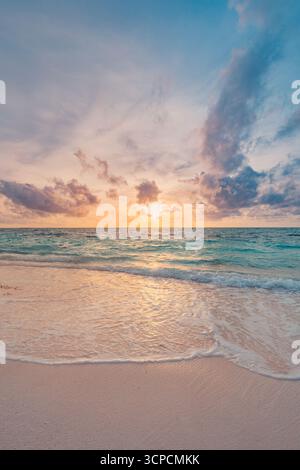 Gorgeous closeup sea sand sky sunset colorful clouds reflection on calm waves tranquil seascape beach background summer evening coastal scenery. Stock Photo