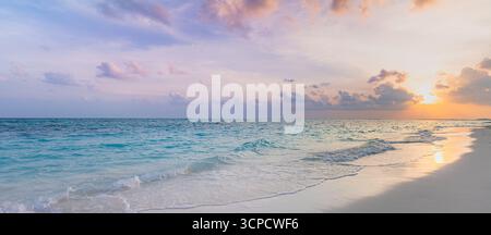 Breathtaking panoramic sunset beach landscape, calm ocean water waves, vibrant serene sky soft clouds, tranquil summer seaside scenery. Summer views Stock Photo