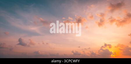 Breathtaking panoramic sunset beach landscape, calm ocean water with gentle waves, vibrant serene sky and clouds, tranquil summer seaside scenery view Stock Photo