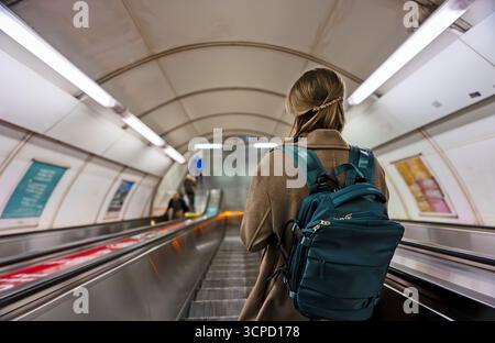 Woman using the escalator in the subway. Stock Photo