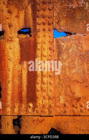 The rough texture of heavily corroded iron plates on the hull of. derelict ship.  British Columbia, Canada Stock Photo