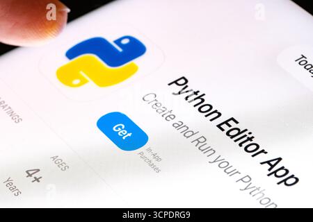 Python editor on iPad with Apples new Liquid Glass updated app design iOS 26 developer tool listing for Python in App Store. Stafford, United Kingdom, Stock Photo