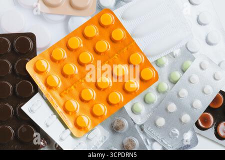 Various pill blister packs arranged on a surface for pharmaceutical examination Stock Photo