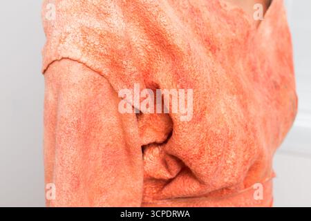 Soft textured fabric drapes elegantly on a model showcasing fashion design in a studio Stock Photo