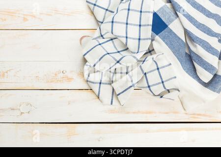 Soft linen fabrics with checked patterns on a rustic wood surface Stock Photo