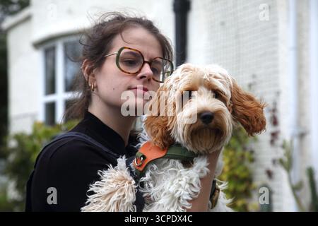 Portrait of a Woman holding a Cockapoo Puppy Surrey England Stock Photo