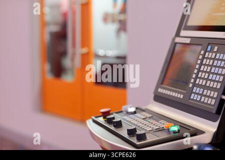 CNC control console of modern machining center. Selective focus. Stock Photo