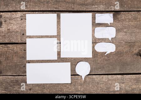 Blank paper forms arranged on a rustic wooden surface for design or planning purposes Stock Photo