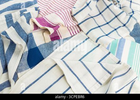 Various kitchen towels displayed in different patterns and colors on a surface Stock Photo