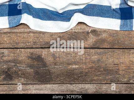 Checkered tablecloth on rustic wooden table creates inviting dining atmosphere Stock Photo