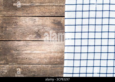 Wooden table with a checked cloth creating a cozy dining atmosphere Stock Photo