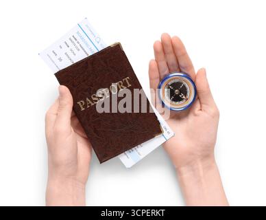 Female hands with passport, ticket and compass on white background, closeup Stock Photo