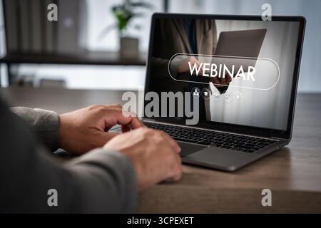 Webinar online learning virtual training streaming, communication technology on laptop in office, business presentation remote work desk, typing hands Stock Photo