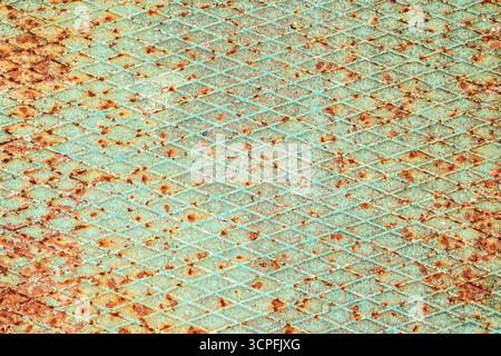 Close-up of a severely worn and rusty metal checker plate, perfect for a unique art or grunge background Stock Photo