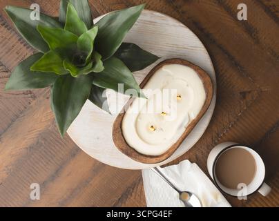 Overhead view of bread bowl candle on rustic table top Stock Photo