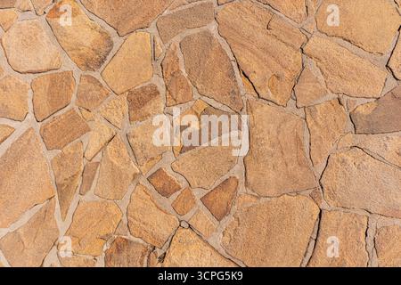 Beautiful stone laying of the road surface. A sample of pavement of paths in a park, country house. environmentally friendly natural material. Stock Photo