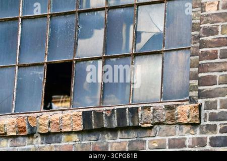 Broken Window in an Old Brick Building of Weathered Factory Stock Photo