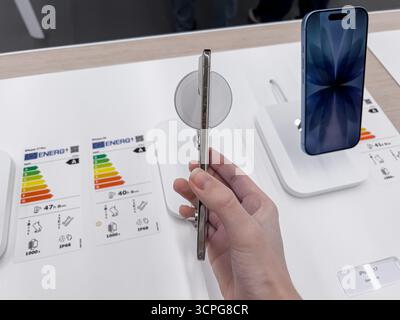 Poznan, Poland - September 20, 2025: iPhone Air new smartphone model prominently featured on a sleek white display, a hand holding the innovative devi Stock Photo