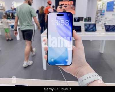 Poznan, Poland - September 20, 2025: iPhone Air device held by a user, demonstrating advanced features and user experience in a modern electronics sho Stock Photo