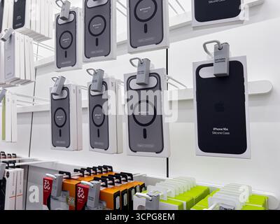 Poznan, Poland - September 20, 2025: Various Apple iPhone Air and iPhone 16e Silicone Cases are prominently showcased on a bright white retail display Stock Photo