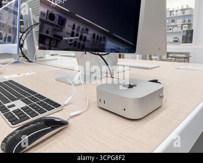 Poznan, Poland - September 20, 2025: An Apple Mac Mini computer, Magic Keyboard, and Magic Mouse are positioned on a clean wooden desk, showcasing new Stock Photo