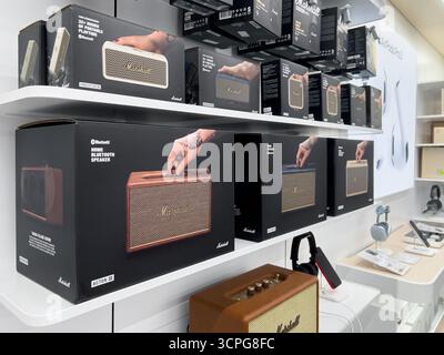 Poznan, Poland - September 20, 2025: Marshall branded Bluetooth speakers and audio devices are neatly presented on shelves in a busy electronics retai Stock Photo