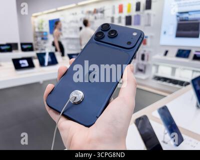Poznan, Poland - September 20, 2025: iPhone 17 Pro, a blue model held by a person, showcasing advanced mobile technology and powerful cameras in a ret Stock Photo