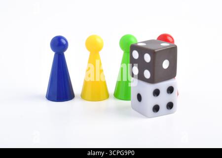 Colorful board game figures and dice isolated on white background Stock Photo