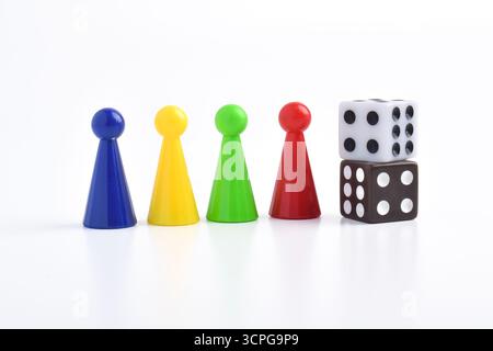 Colorful board game figures and dice isolated on white background Stock Photo