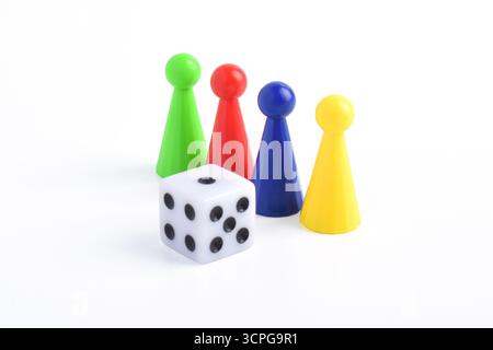 Colorful board game figures and dice isolated on white background Stock Photo