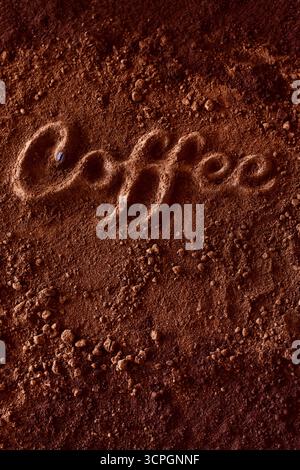 Word ''coffee'' spelled out in ground coffee on a rich dark coffee texture Stock Photo