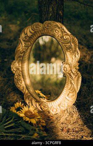 Old decorative antique mirror in meadow. High quality photo Stock Photo