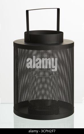 Tall circular black iron mesh lamp with hanging handle isolated nature background with clipping path Stock Photo