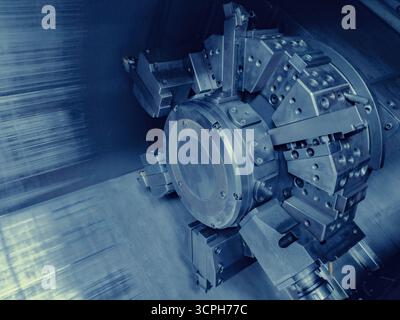 CNC Machine Tool in Operation. Close-up view of a high-tech CNC machine tool turret. Ideal for illustrating advanced technology in industrial and engi Stock Photo